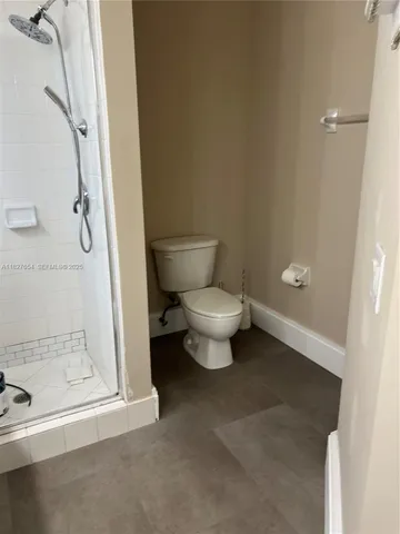 a bathroom with a double vanity sink toilet and shower