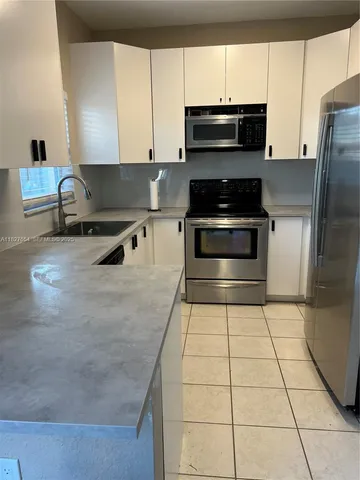 a kitchen with a stove a microwave and a counter top space