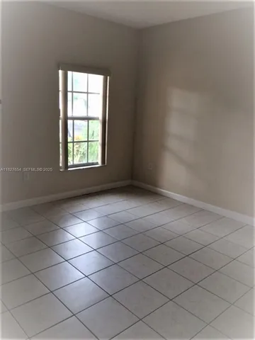 a bathroom with double vanity and a mirror