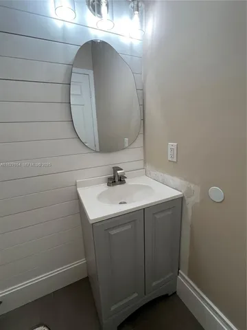 a bathroom with a double vanity sink and mirror with shower