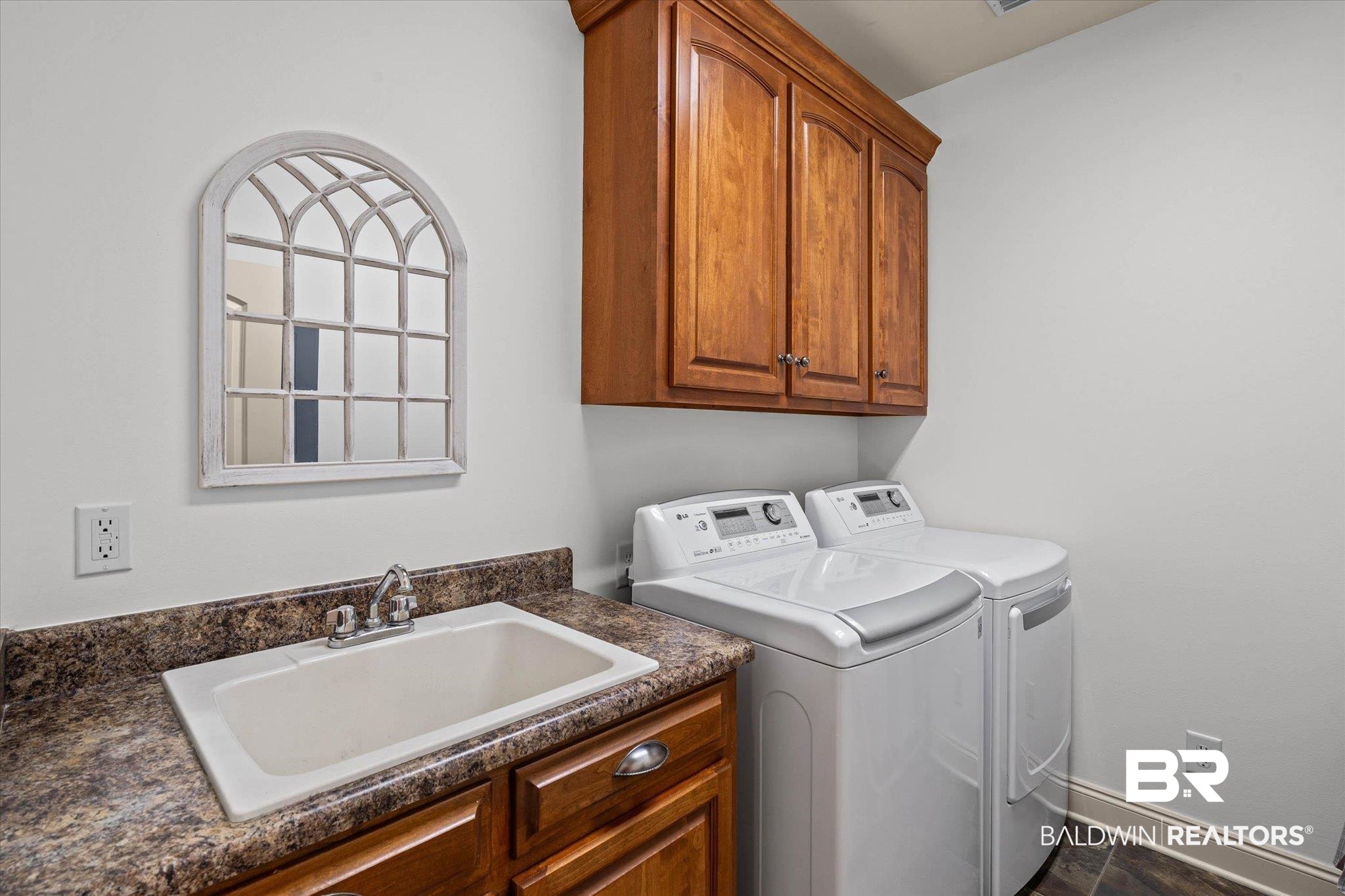 3459 Rue Royal Mobile, AL 36693 - Photo 24 of 31 Utility room featuring a built-in sink with a countertop, wood cabinetry, and wood-finish flooring