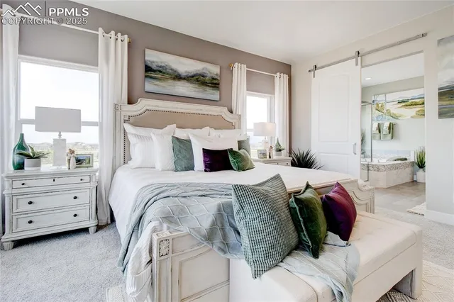 a bedroom with a bed and a painting on the wall