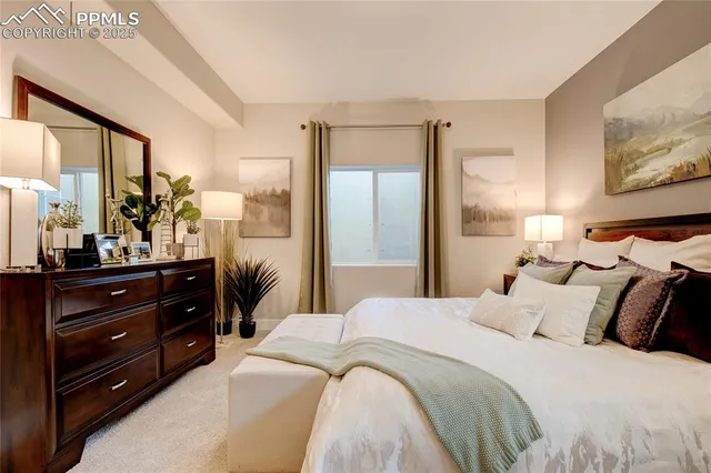 a bedroom with a bed and a large mirror