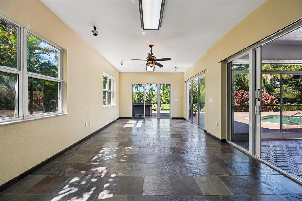 4181 Southwest 141st Avenue Davie, FL 33330 - Photo 23 of 61 a view of a hallway with wooden floor and a chandelier