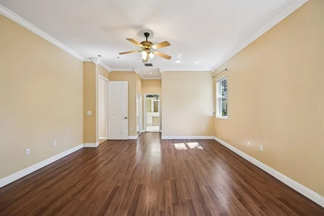 an empty room with a window and wooden floor
