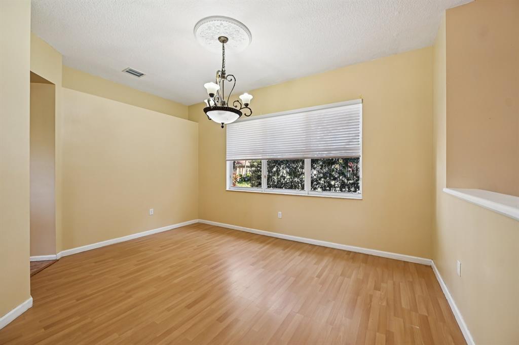 4181 Southwest 141st Avenue Davie, FL 33330 - Photo 6 of 61 a view of an empty room with wooden floor and a window