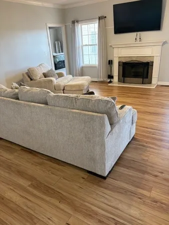 a view of swimming pool with garden and patio