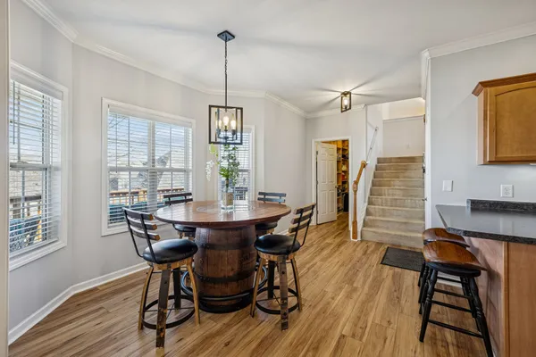 a view of a hallway view with living room and wooden floor