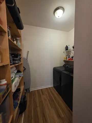 a view of a hallway view with living room and wooden floor