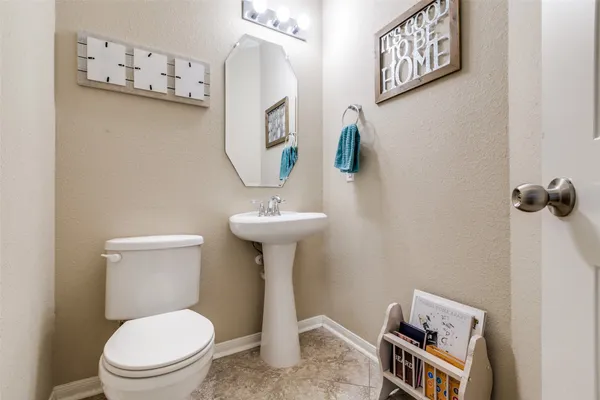 a white toilet sitting next to a bathroom sink