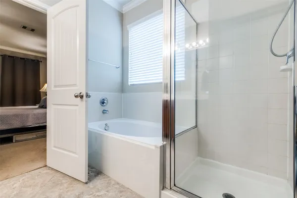 a bathroom with a tub a sink and a mirror