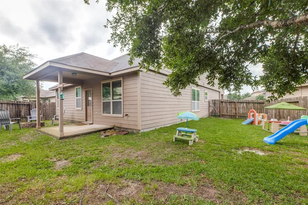 a backyard of a house with table and chairs