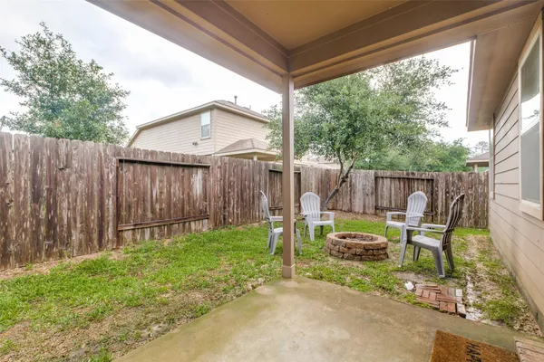 a backyard of a house with table and chairs