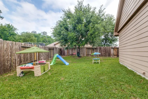 a backyard of a house with table and chairs