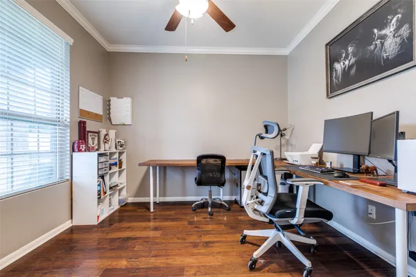 a view of a workspace with furniture and a window