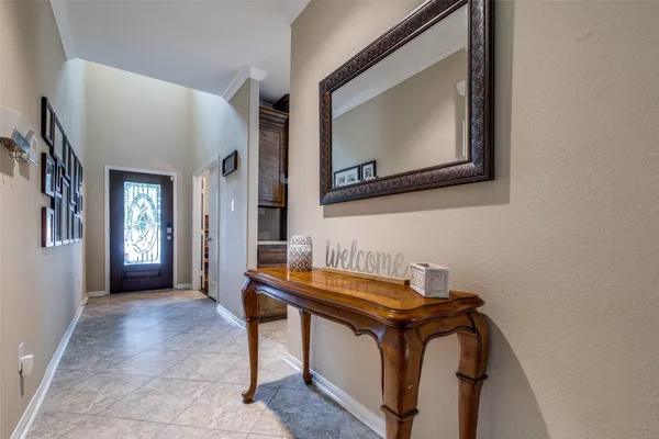 a view of an entryway with table and mirror