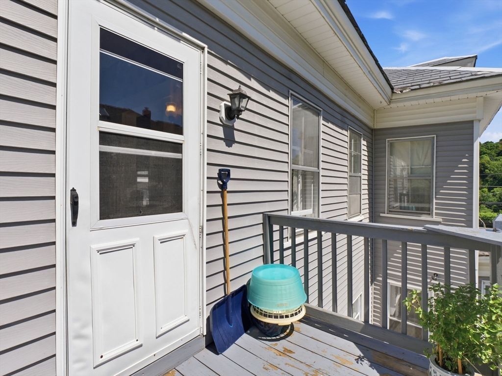 223 Stackpole Street Lowell, MA 01852 - Photo 33 of 42 a view of a porch with furniture and wooden floor
