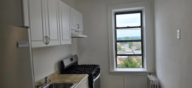a kitchen with windows and refrigerator