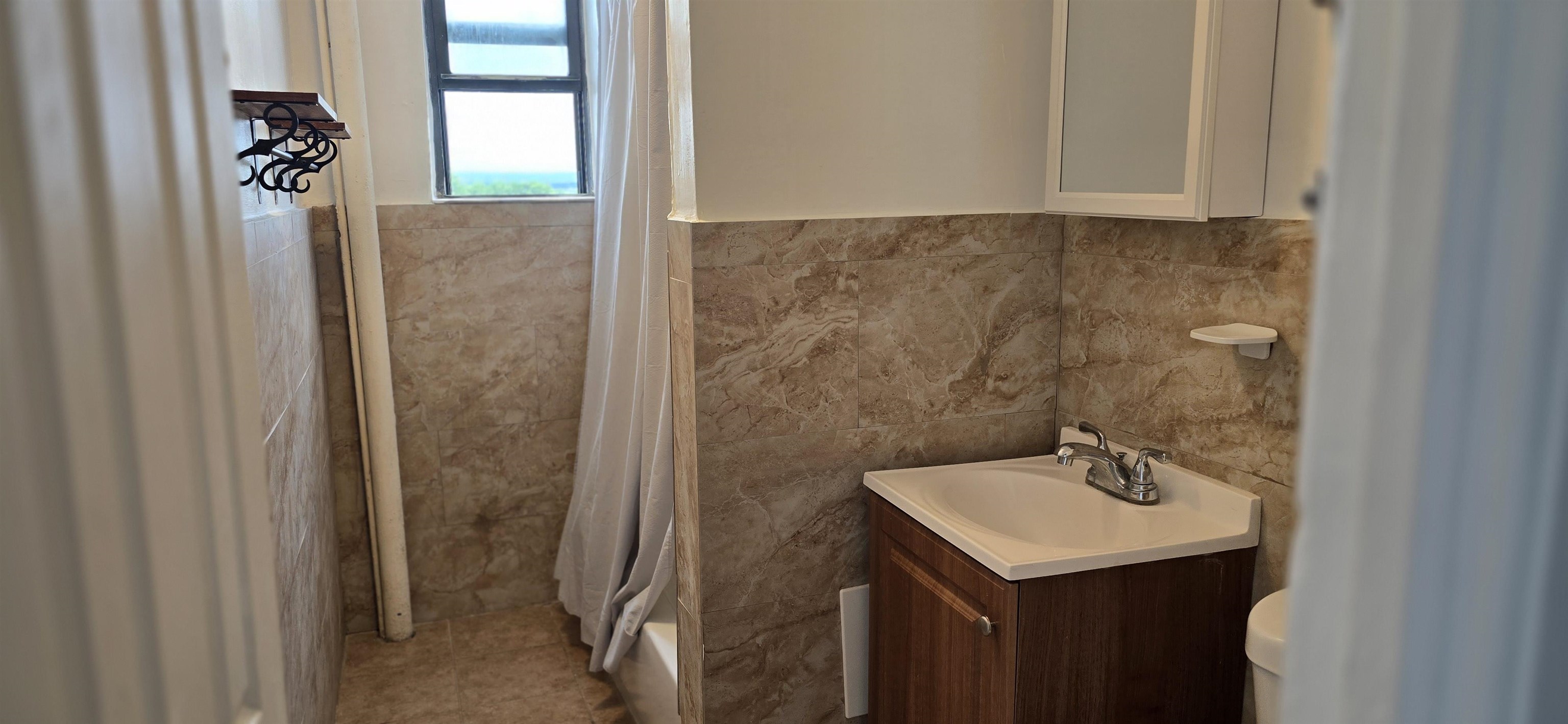 277 Harrison Avenue, Unit E4 Jersey City, NJ 07304 - Photo 5 of 13 a bathroom with a sink and mirror