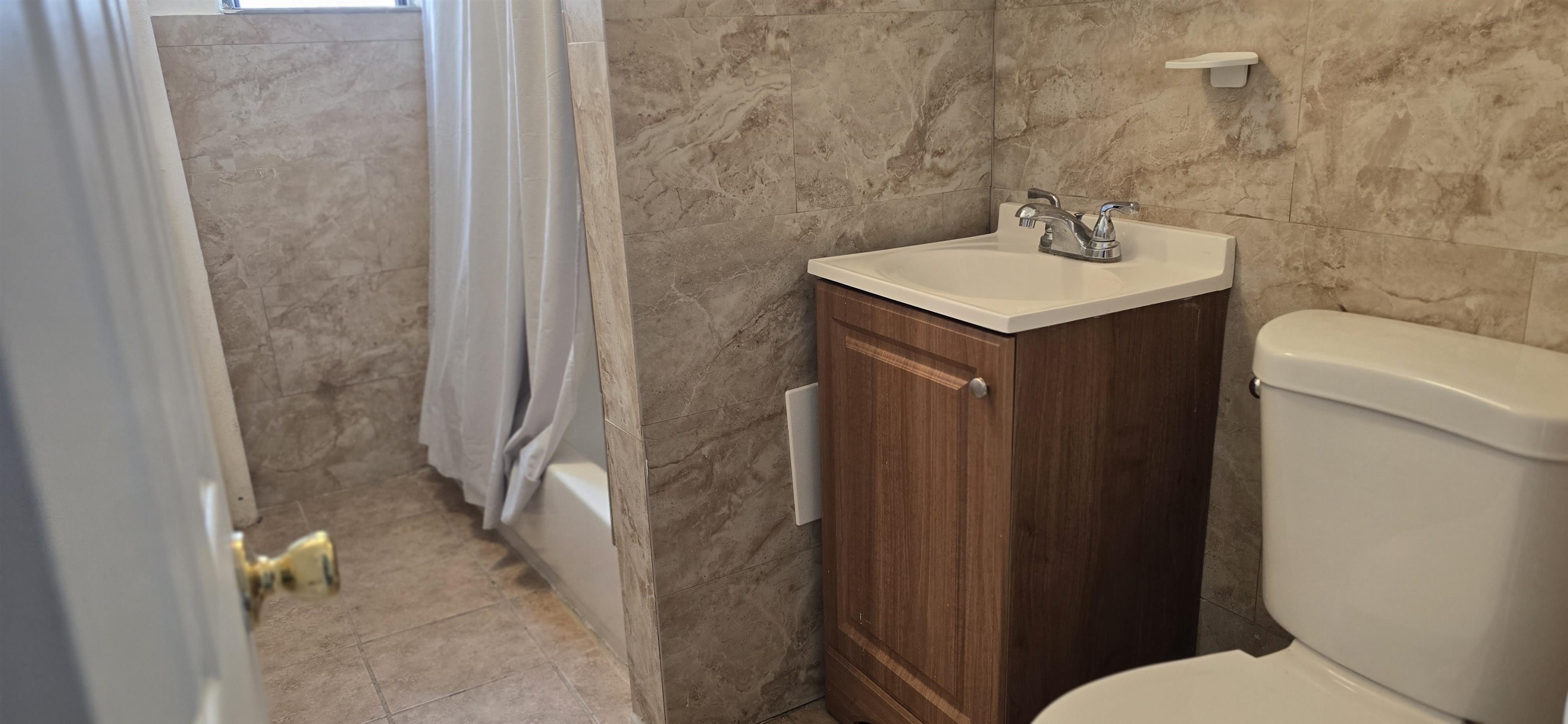 277 Harrison Avenue, Unit E4 Jersey City, NJ 07304 - Photo 6 of 13 a bathroom with a sink a toilet and shower