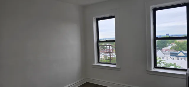 an empty room with windows and closet