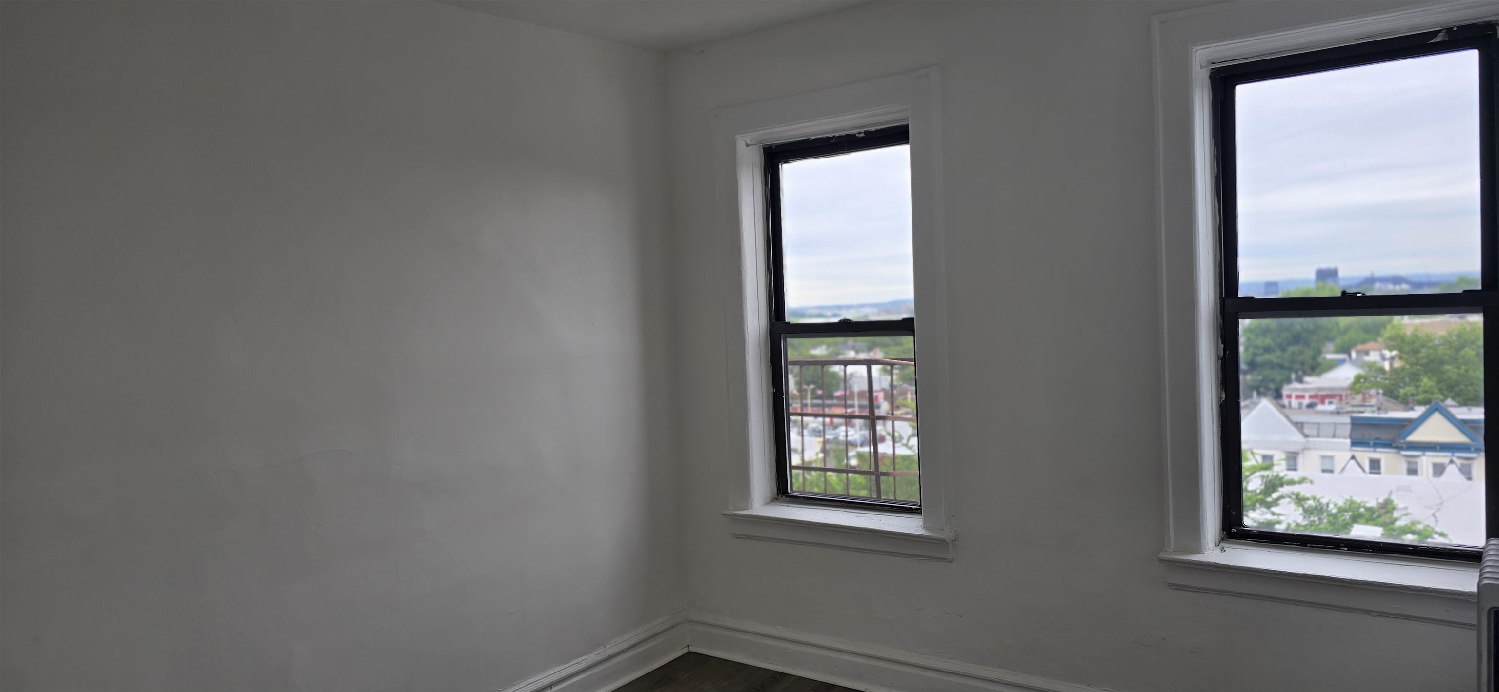 277 Harrison Avenue, Unit E4 Jersey City, NJ 07304 - Photo 10 of 13 an empty room with windows and closet