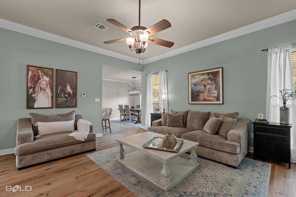 116 Augusta Avenue Benton, LA 71006 - Photo 11 of 38 a living room with furniture and a chandelier