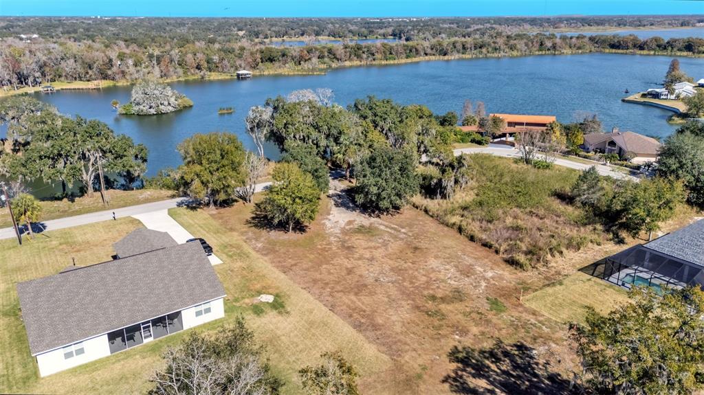 2577 Rogers Road Lakeland, FL 33812 - Photo 2 of 8 an aerial view of a house with a yard and lake view