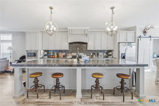 a bedroom with a large bed and a chandelier