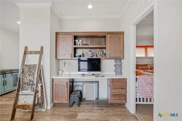 a kitchen with stainless steel appliances a white table chairs and a refrigerator