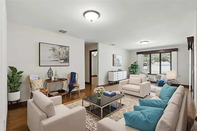 a living room with furniture and wooden floor