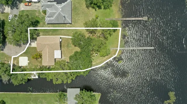 a backyard of a house with wooden floor and outdoor seating