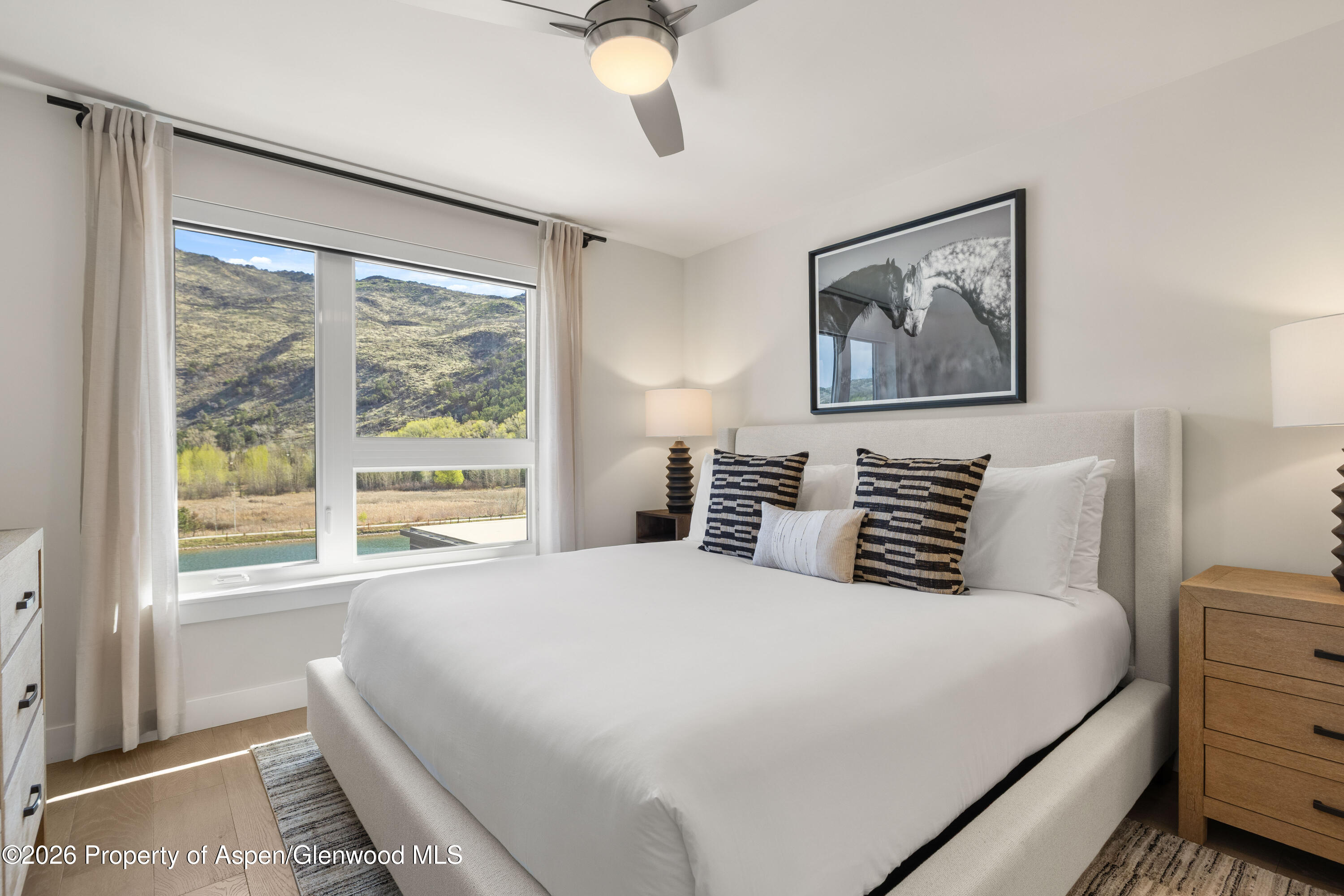 85 Kodiak Drive, Unit 320 Basalt, CO 81621 - Photo 11 of 20 a bedroom with a large bed and a large window