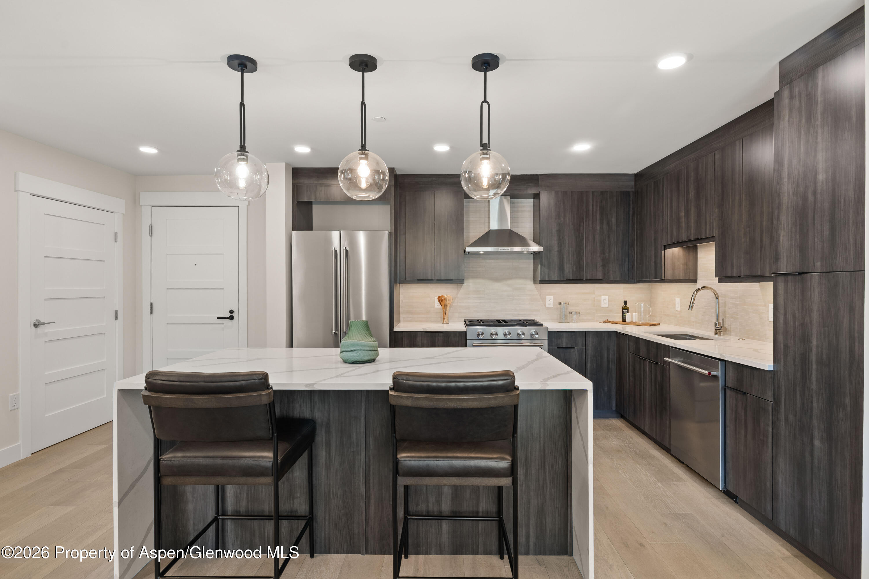 85 Kodiak Drive, Unit 320 Basalt, CO 81621 - Photo 5 of 20 a kitchen with kitchen island granite countertop a sink a center island and stainless steel appliances