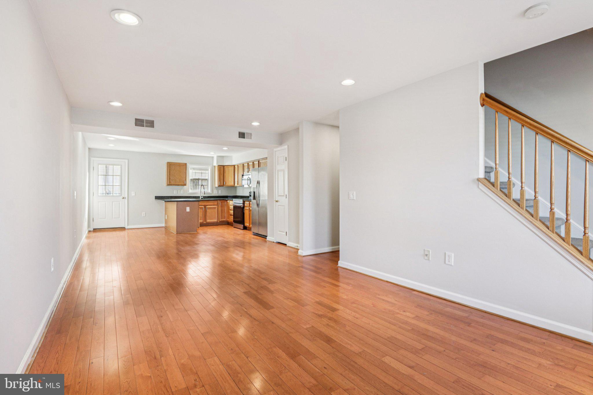 2675 Edgemont Street Philadelphia, PA 19125 - Photo 3 of 18 a view of empty room with wooden floor and kitchen