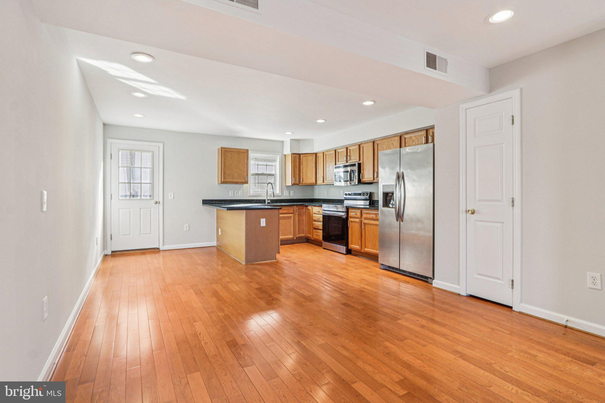 2675 Edgemont Street Philadelphia, PA 19125 - Photo 4 of 18 a view of kitchen with stainless steel appliances granite countertop a stove top oven a sink and a refrigerator