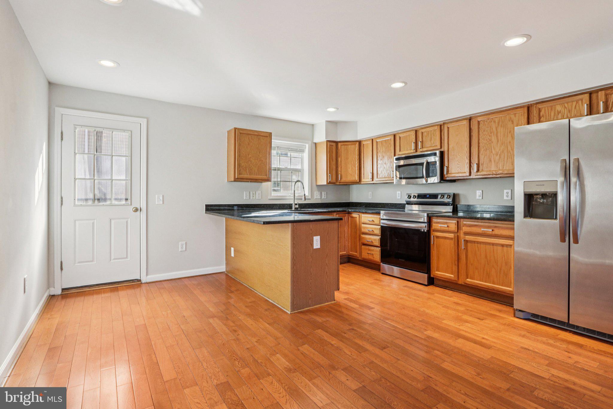 2675 Edgemont Street Philadelphia, PA 19125 - Photo 5 of 18 a kitchen with stainless steel appliances granite countertop a stove top oven a sink and a refrigerator