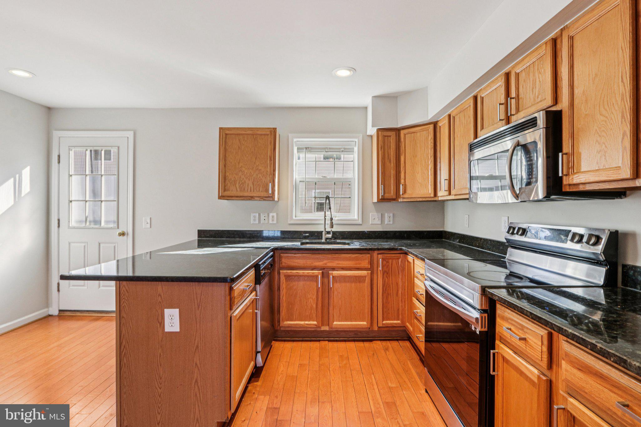 2675 Edgemont Street Philadelphia, PA 19125 - Photo 6 of 18 a kitchen with stainless steel appliances granite countertop a sink stove and cabinets