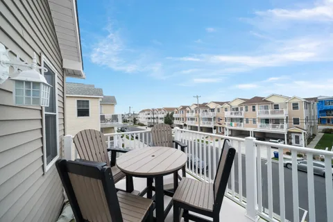 a view of a chairs and table on the roof deck