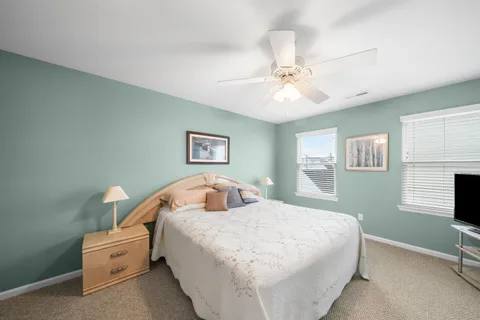 a bedroom with a white bed and a chandelier