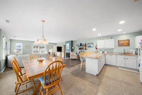 a living room with furniture a dining table and chairs