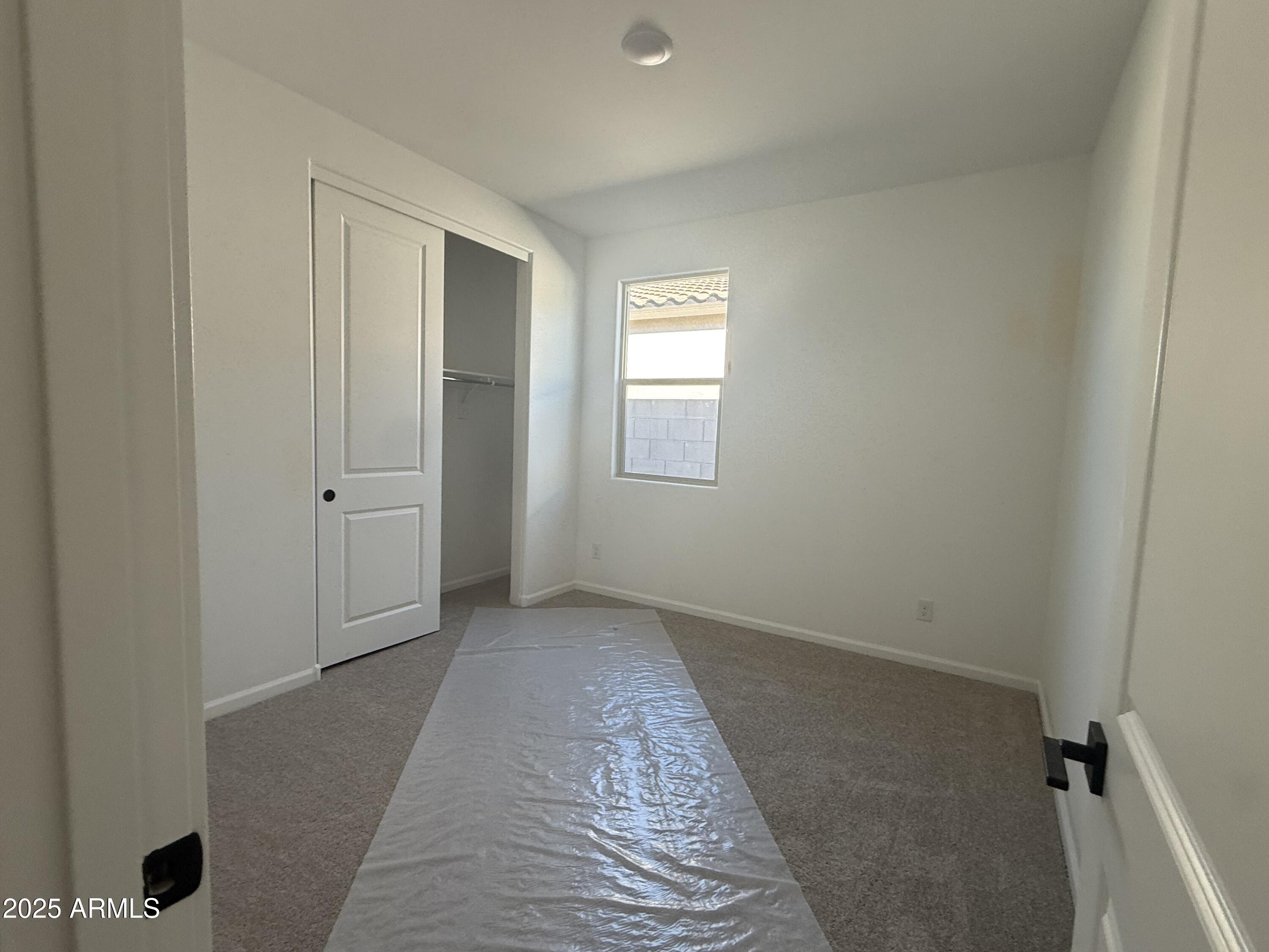 9620 West Tamarisk Avenue Tolleson, AZ 85353 - Photo 11 of 32 an empty room with windows