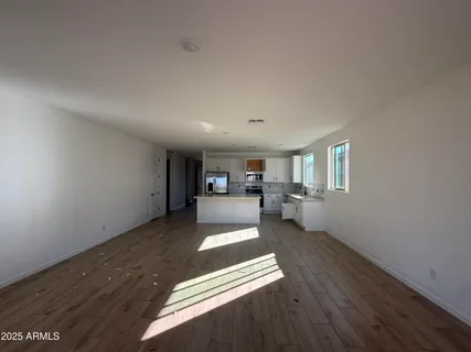 a view of a livingroom with a furniture wooden floor and window