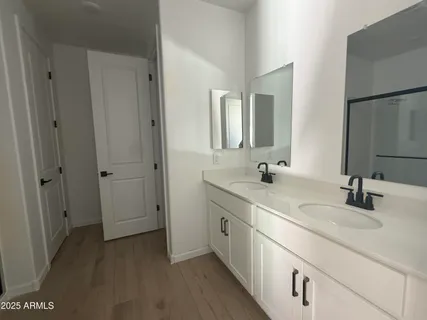 a bathroom with 2 sink and a mirror