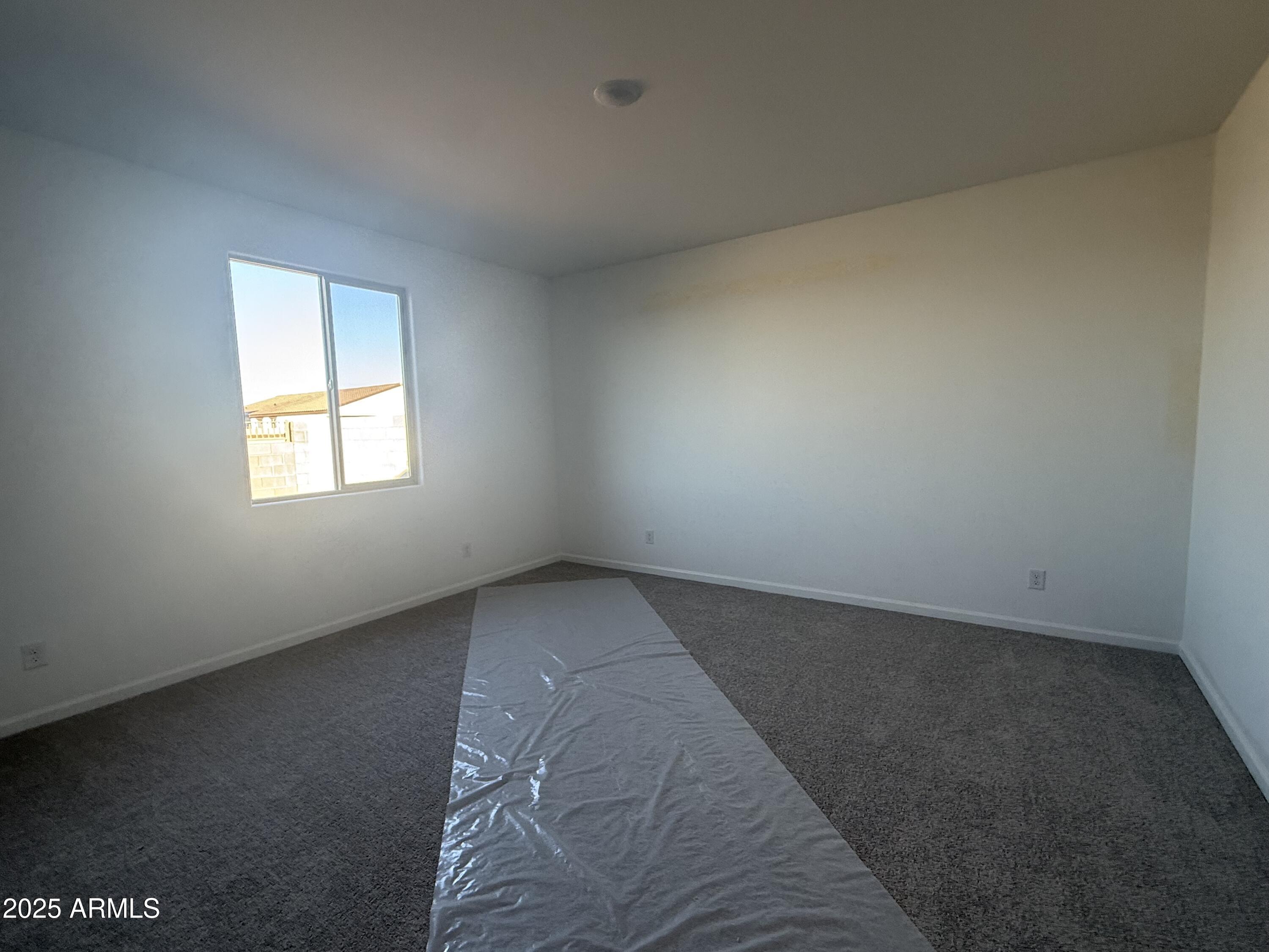 9620 West Tamarisk Avenue Tolleson, AZ 85353 - Photo 19 of 32 an empty room with a window