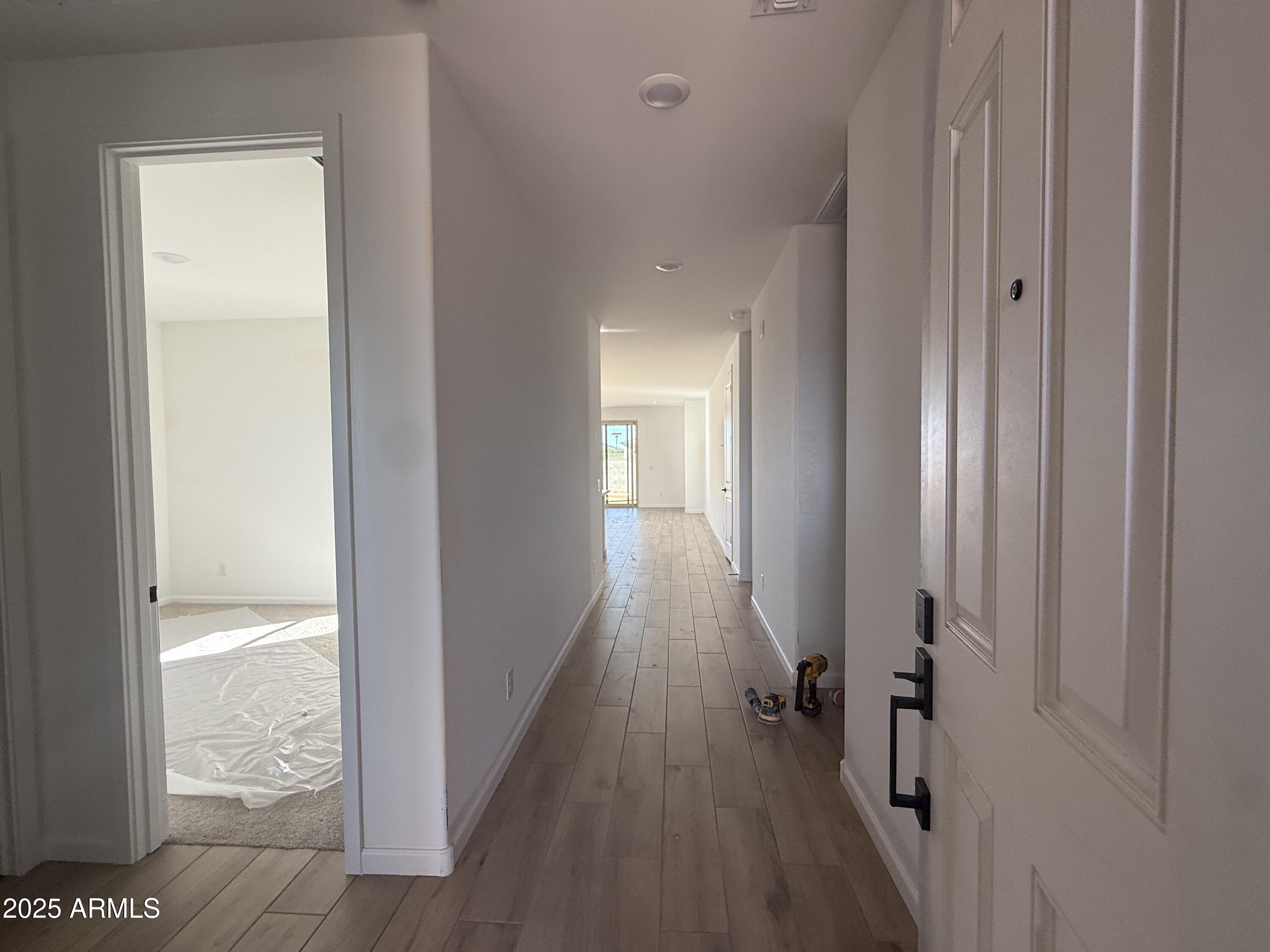 9620 West Tamarisk Avenue Tolleson, AZ 85353 - Photo 4 of 32 a view of hallway with wooden floor