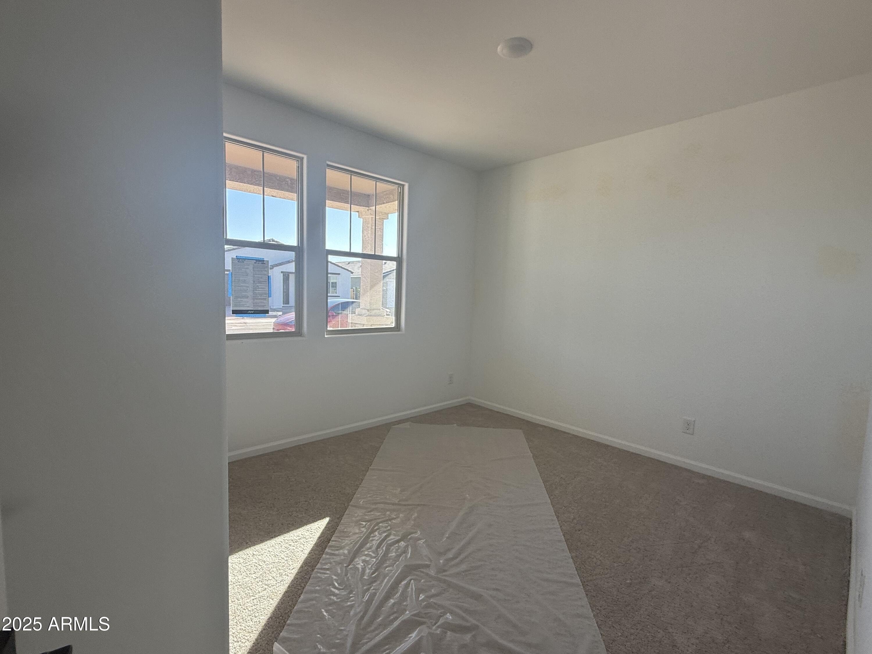 9620 West Tamarisk Avenue Tolleson, AZ 85353 - Photo 5 of 32 an empty room with windows