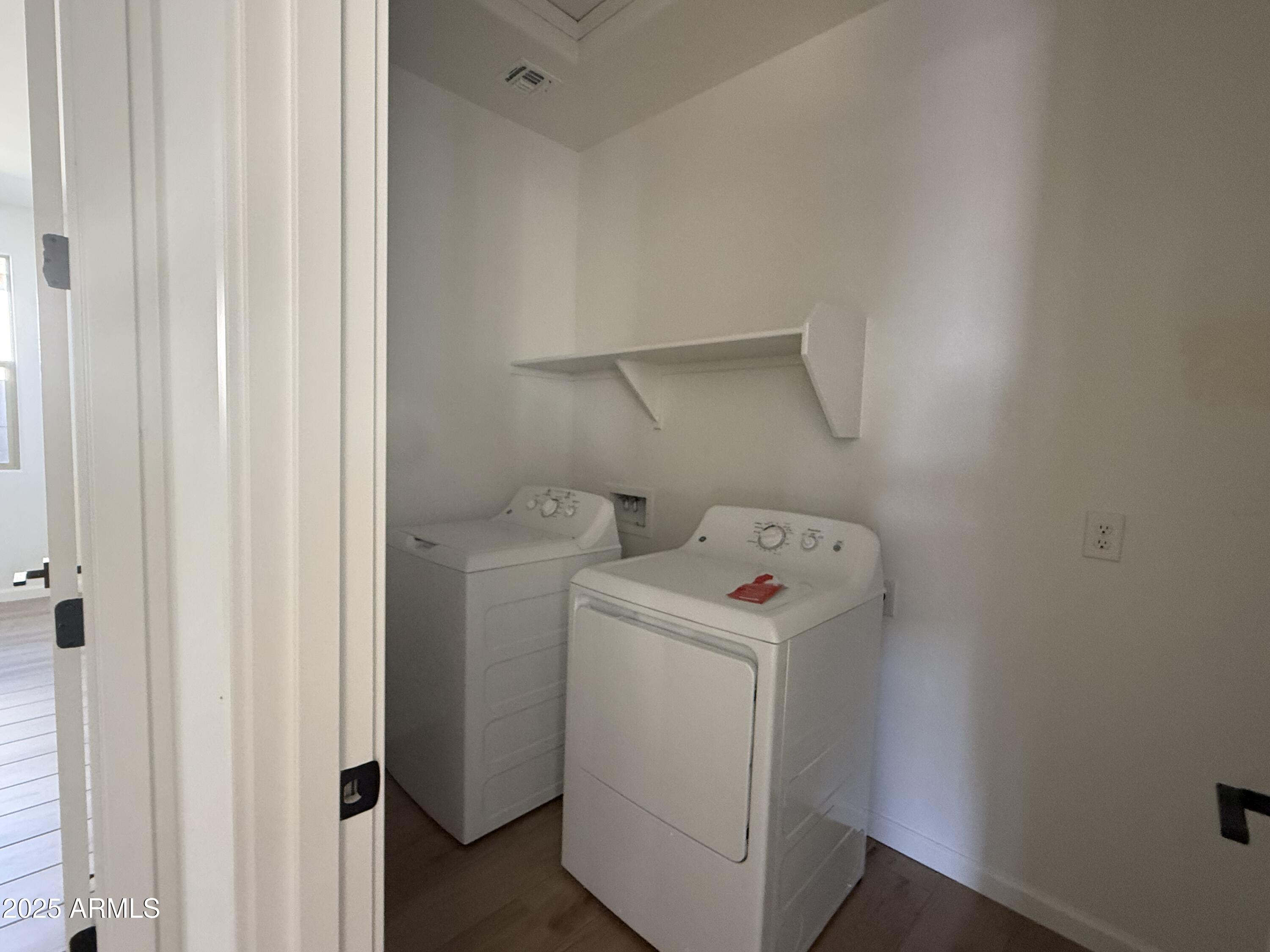 9620 West Tamarisk Avenue Tolleson, AZ 85353 - Photo 9 of 32 a view of storage and utility room with a washer and dryer