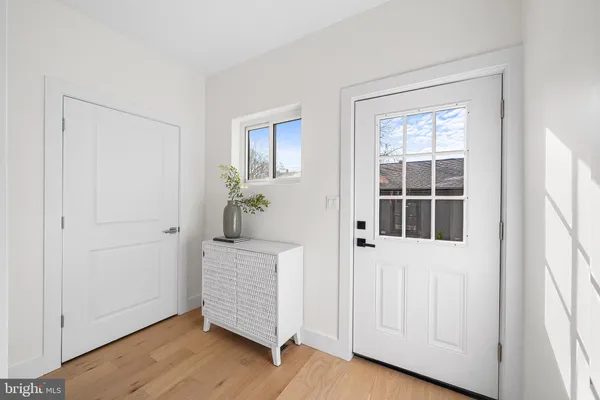 a hallway with wooden floor and windows