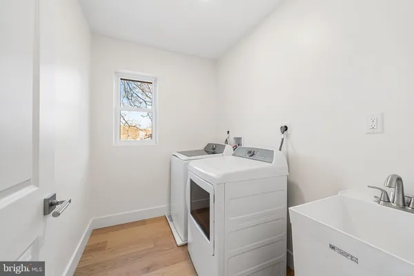 a utility room with a sink dryer and washer